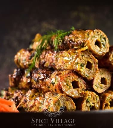Seekh kebabs stacked hot off the coal grill.