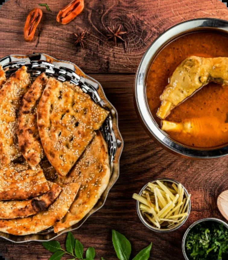 Breads and curry laid out on a wooden board, ready to be boxed.